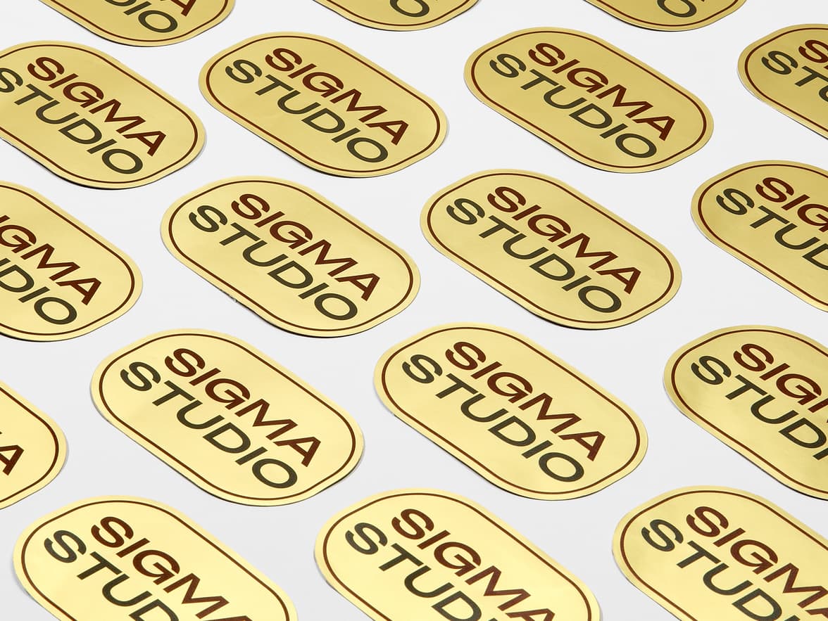 A collection of customized gold metallic stickers in the shape of a rounded rectangle.
