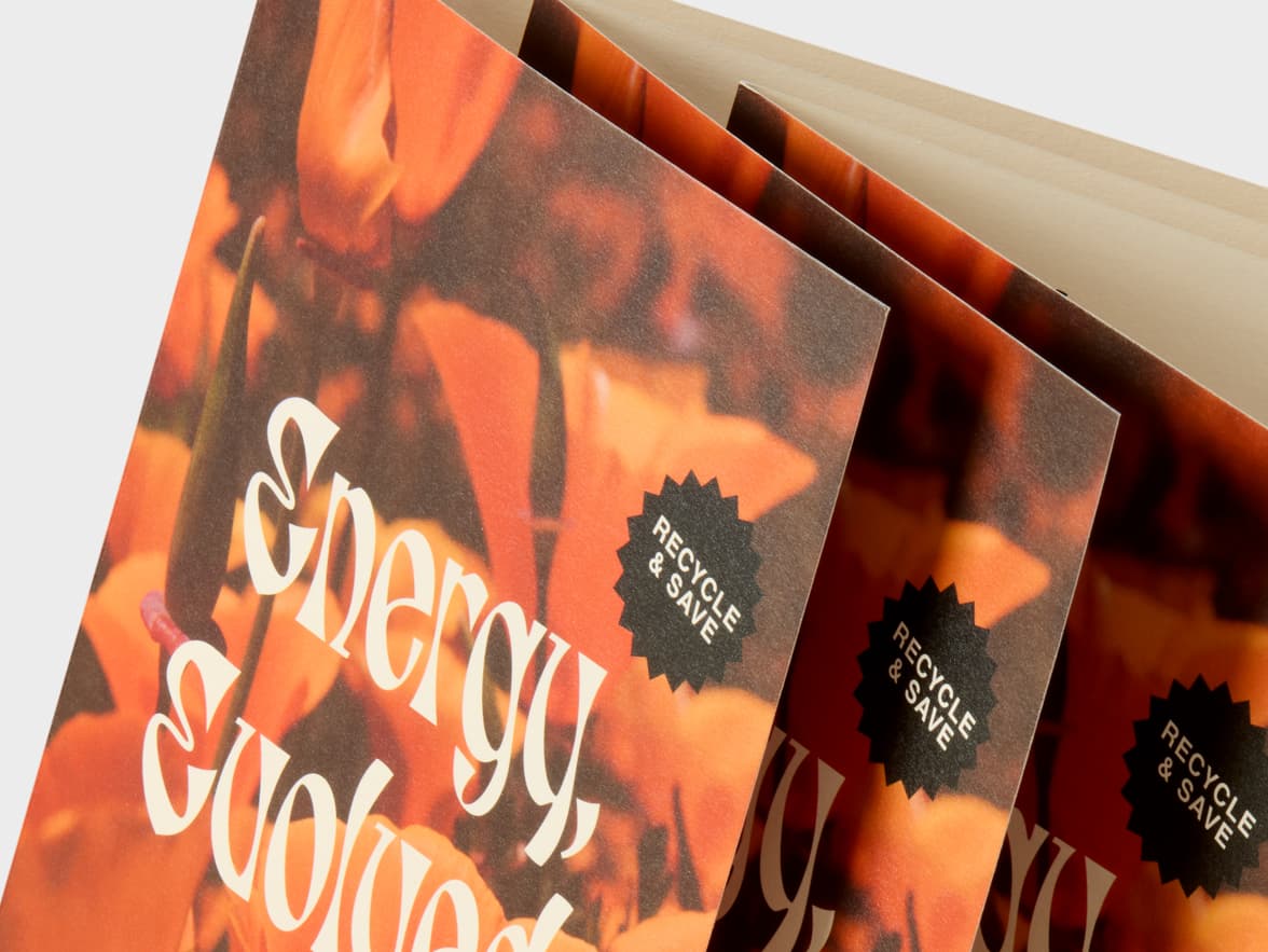 Fanned orange brochures with "Energy evolved" and "Recycle & Save" text.