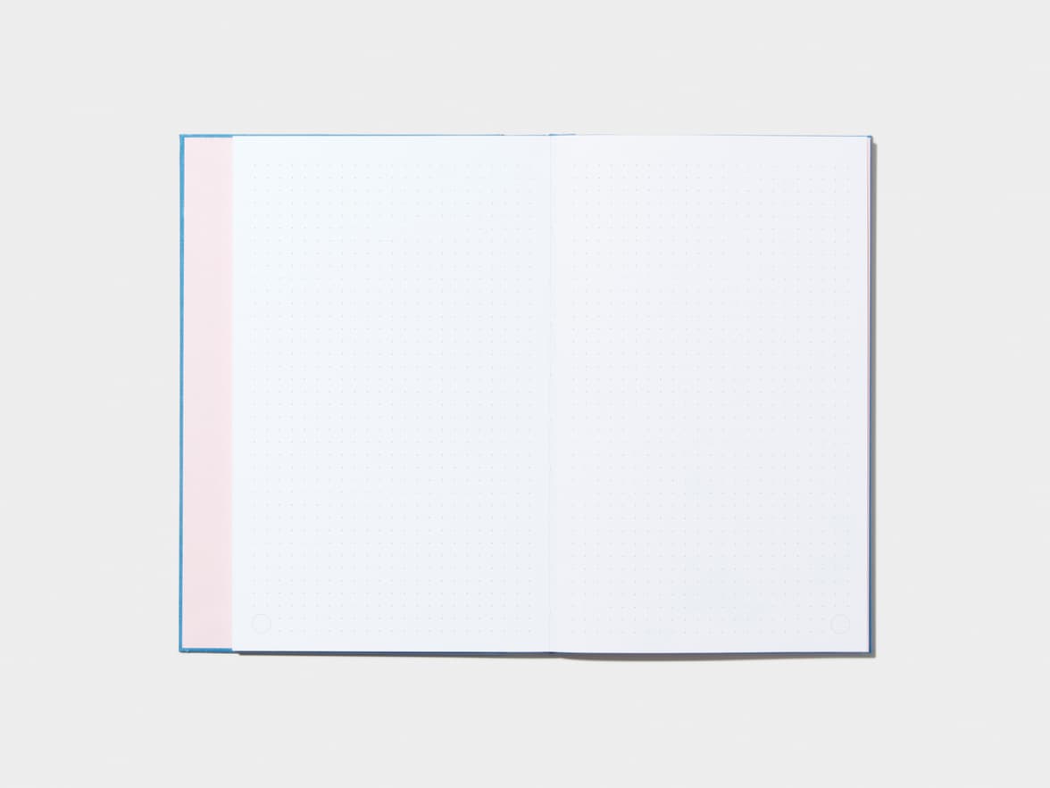 An opened Sky Blue Hardcover Notebook with dotted pages 