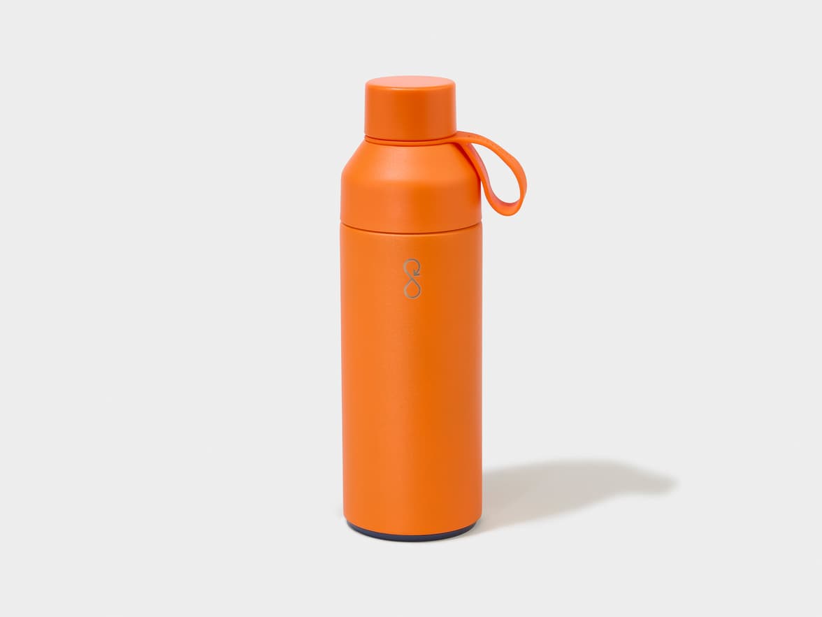 An orange water bottle with a dark blue base and an orange loop handle, featuring a silver stylized S-shaped logo on its side.