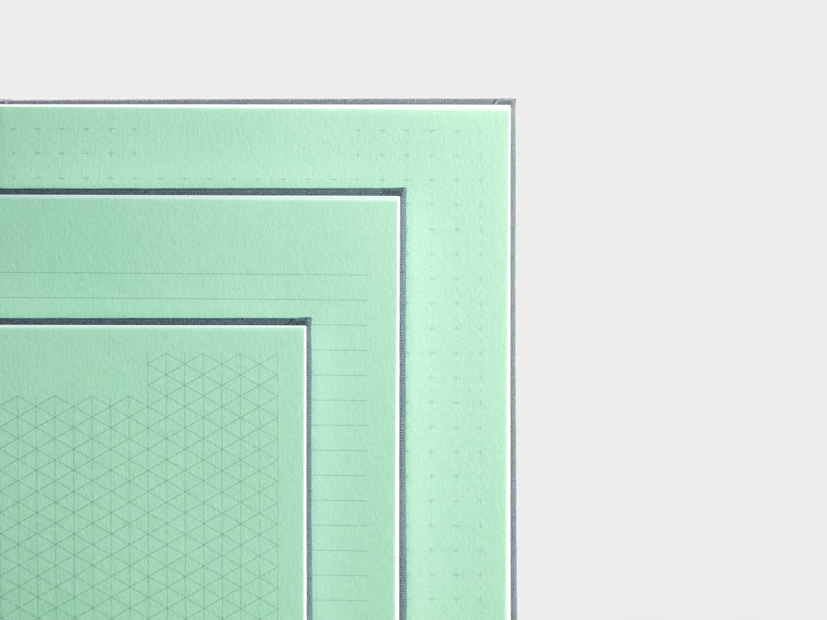 Close ups of opened Charcoal Grey  Planners with various dotted and lined page types 