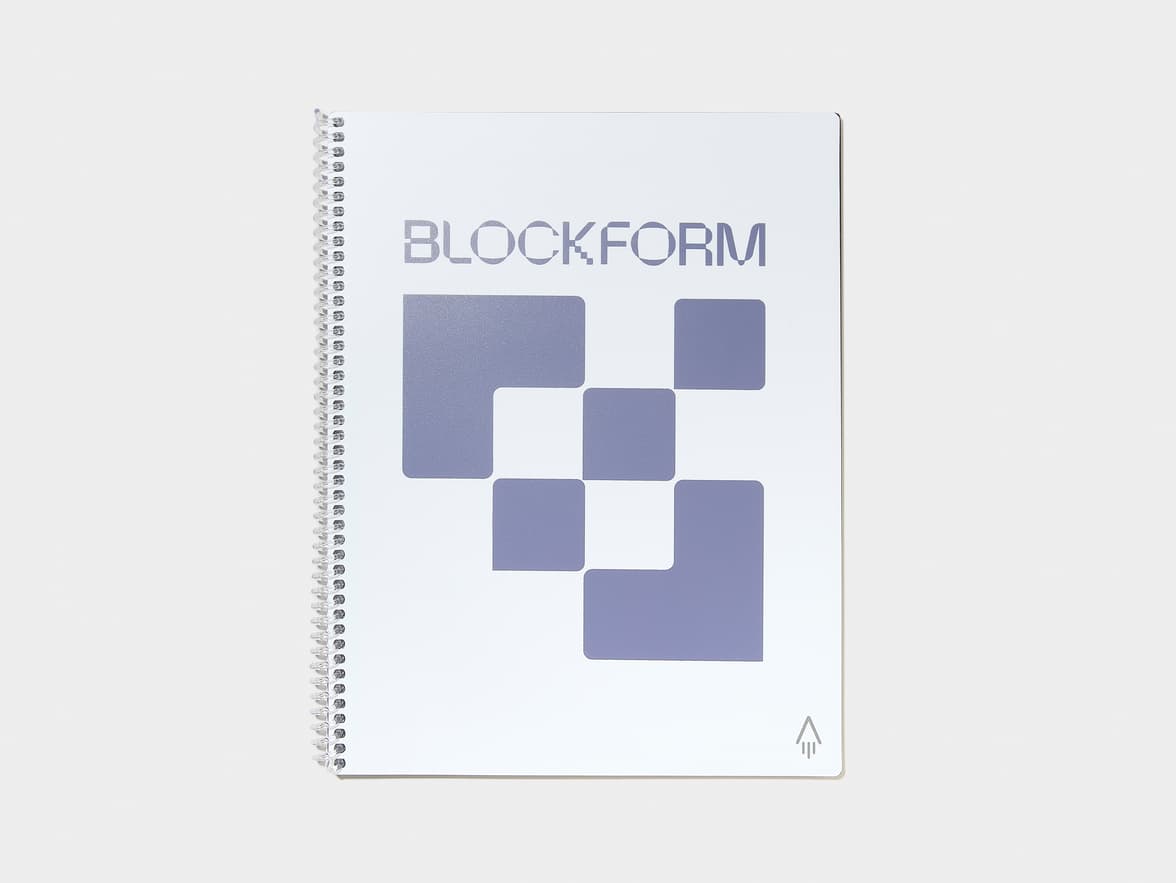 White spiral notebook with 'BLOCKFORM' branding, a geometric design of purple squares, and an arrow logo on the cover.