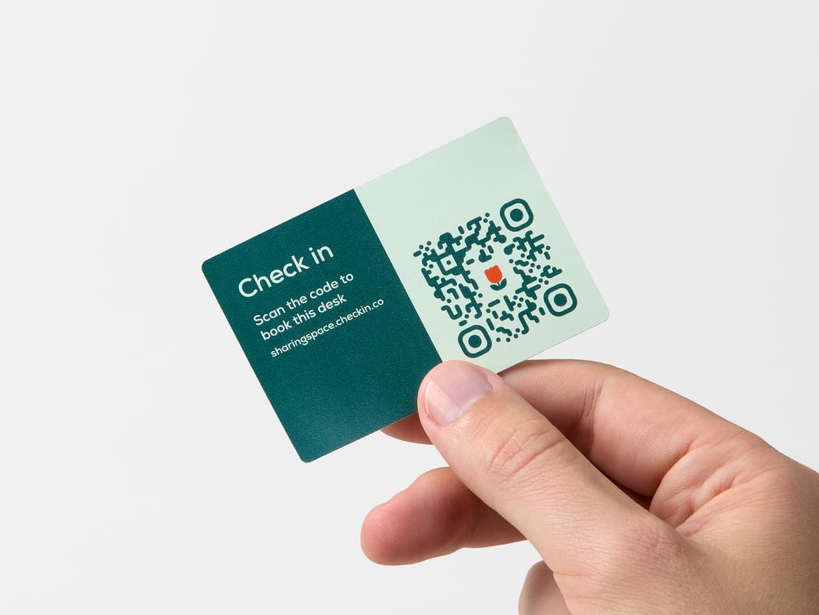 A hand holding a customized rectangular coated sticker.