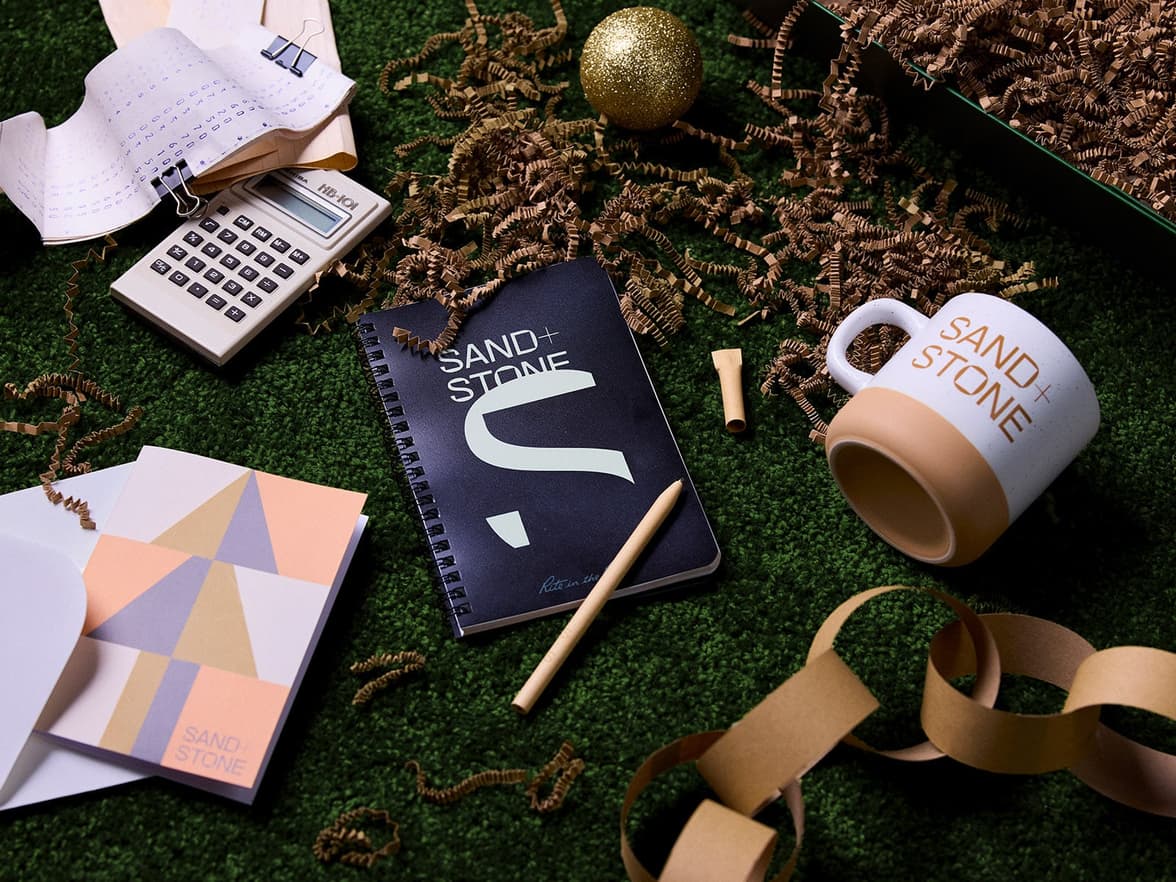 variety of branded merch alongside tinsel & a glittery bauble