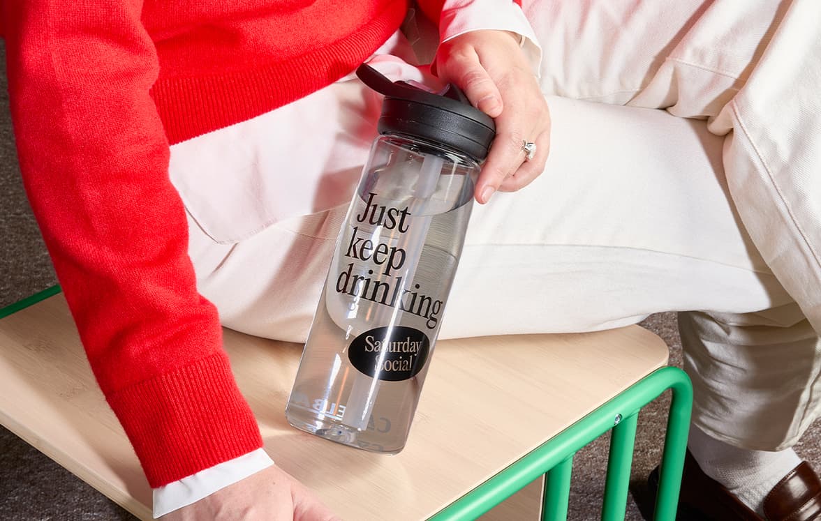 A person holding a customized CamelBak water bottle.