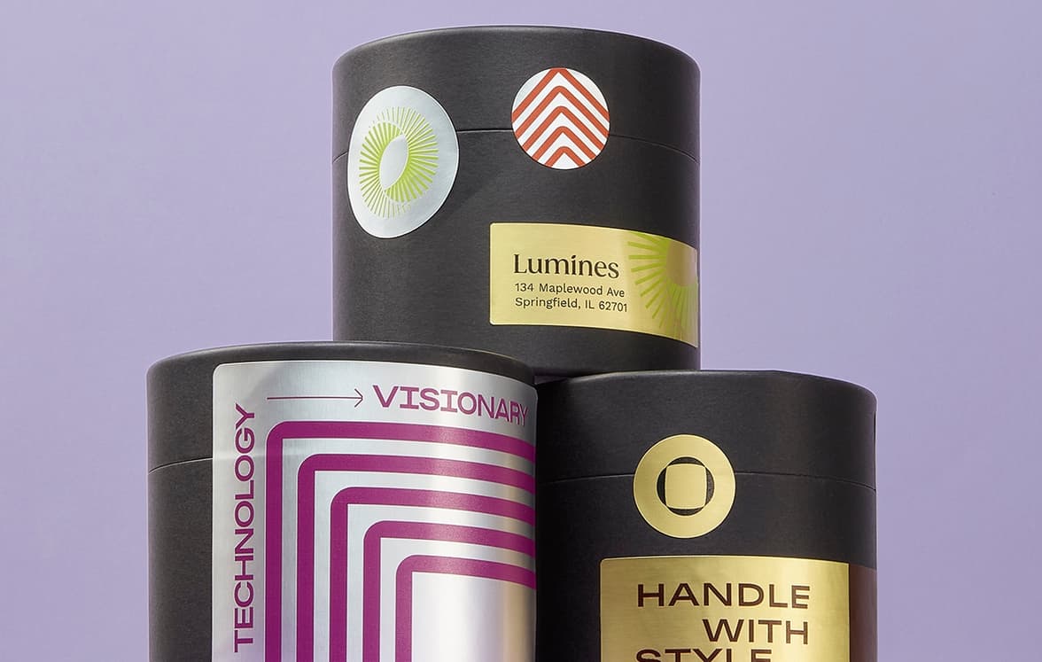 Customized metallic stickers, varying in size and color placed on packaging.