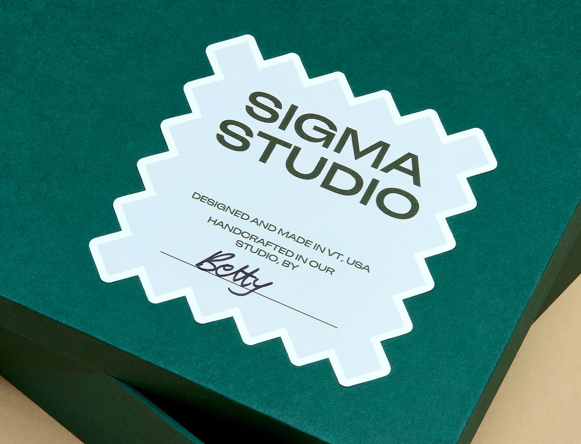 A customized sticker with a handwritten name placed on a packaging box.