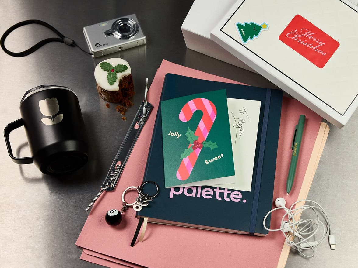 variety of branded merch alongside a Holiday cake