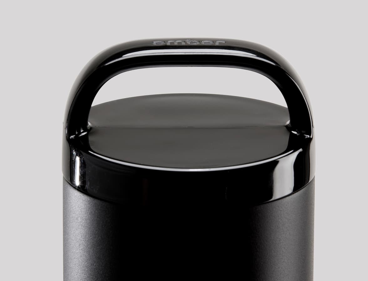 Detailed image of the top of a black tumbler.